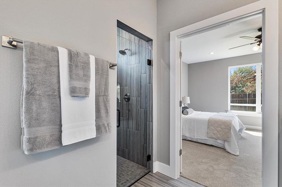 Bathroom with ceiling fan and an enclosed shower