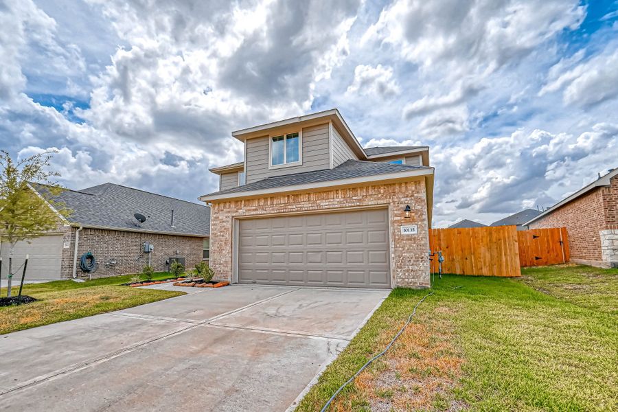 Representative exterior photo of a completed home built from the Floor Plan 2340 by Colina Homes in Grand Magnolia, Magnolia, TX (Image 24). Representative exterior photo of a completed home built from the Floor Plan 2340 by Colina Homes in Grand Magnolia, Magnolia, TX (Image 24).