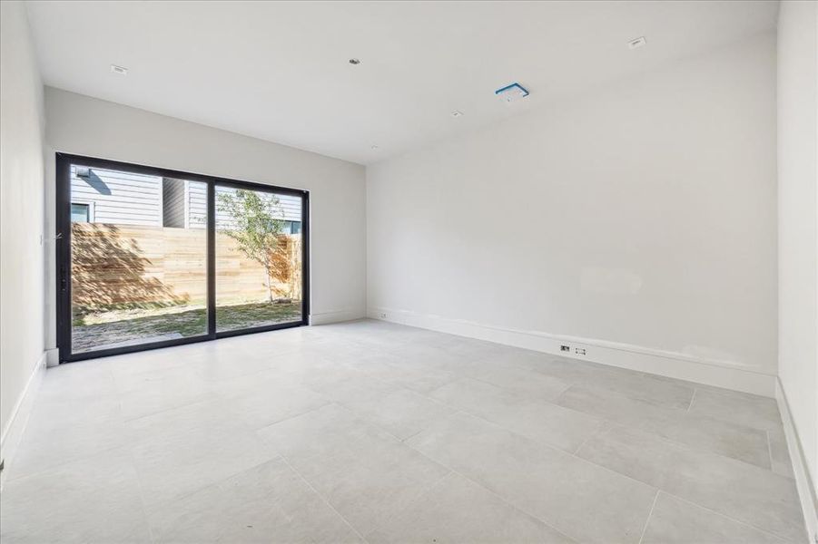 Bedroom 3 on the ground floor provides access to the backyard and could be an amazing game room.