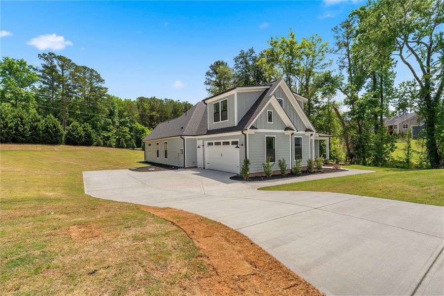 A newly constructed residence features ample yard