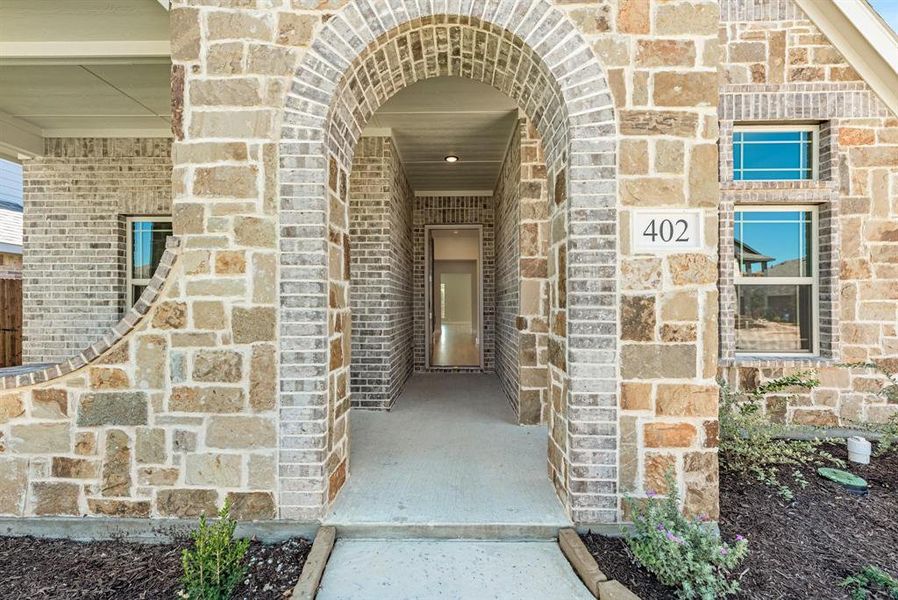 Arched entryway featuring a blend of natural stone and brickwork Arched entryway featuring a blend of natural stone and brickwork