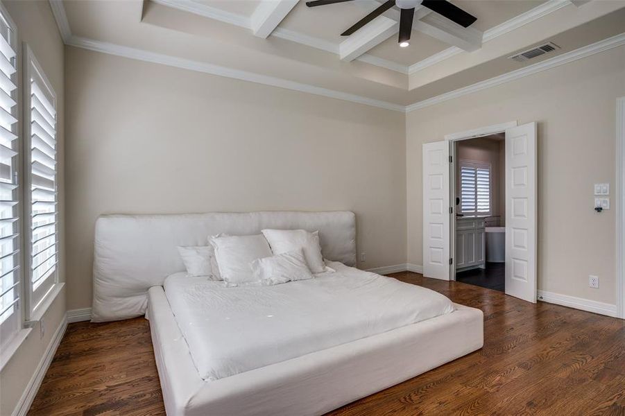 Bedroom featuring coffered ceiling, ceiling fan, crown molding, beamed ceiling, and dark hardwood / wood-style floors