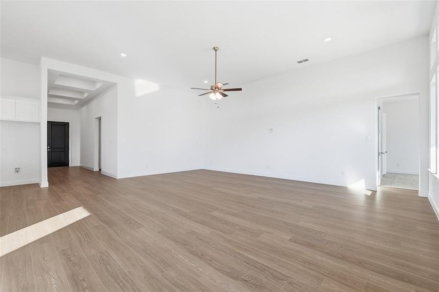 Unfurnished living room featuring light wood-style flooring, ceiling fan, and recessed lighting Unfurnished living room featuring light wood-style flooring, ceiling fan, and recessed lighting