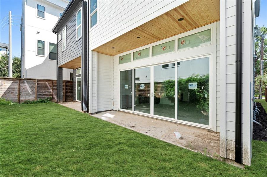 Fabulous bank of windows and sliding glass door lead to the covered back patio.