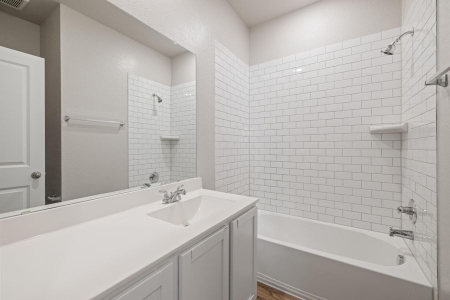 Bathroom featuring vanity and shower / tub combination Bathroom featuring vanity and shower / tub combination