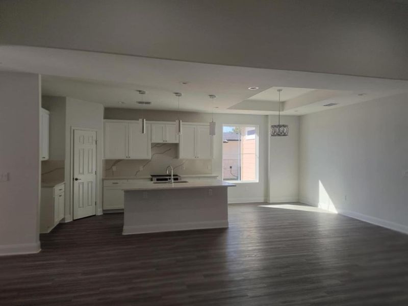 Kitchen featuring white cabinets, decorative light fixtures, a kitchen island with sink, dark wood-style floors, and recessed lighting, Dining Area Kitchen featuring white cabinets, decorative light fixtures, a kitchen island with sink, dark wood-style floors, and recessed lighting, Dining Area