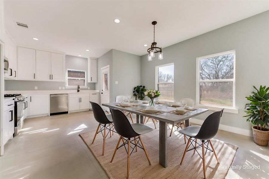 Dining room featuring sink and a chandelier