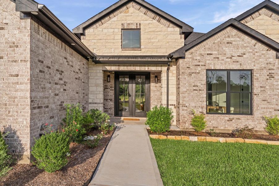 Charming covered front porch perfect for morning coffee and relaxing views, featuring elegant wood posts and spacious sitting area. Charming covered front porch perfect for morning coffee and relaxing views, featuring elegant wood posts and spacious sitting area.