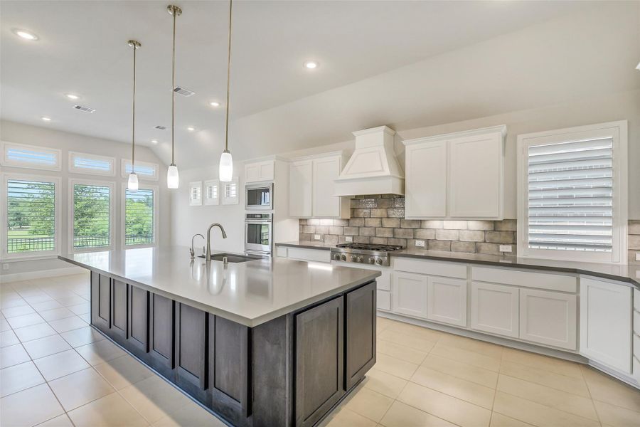 The kitchen has stainless steel Kitchenaid appliances including six burner cooktop, double ovens and a microwave. The kitchen has stainless steel Kitchenaid appliances including six burner cooktop, double ovens and a microwave.