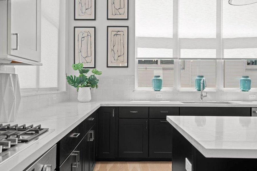 Culinary dreams come alive in this meticulously appointed kitchen, featuring elegant stone counters and a gas range. Culinary dreams come alive in this meticulously appointed kitchen, featuring elegant stone counters and a gas range.