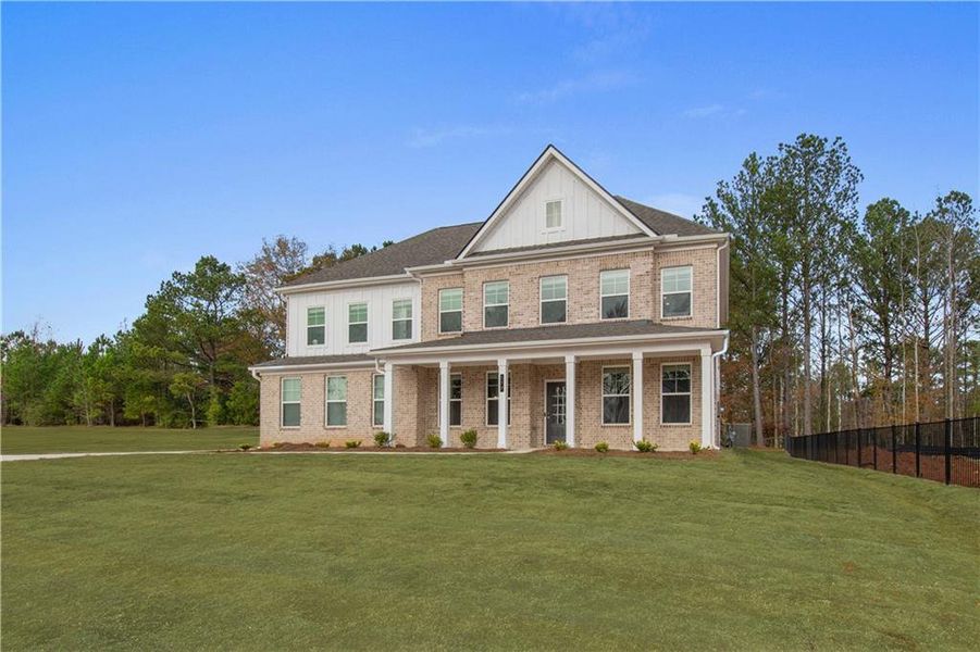 Front exterior of a new home in Cambria at Traditions, Hampton, GA, highlighting curb appeal (Image 2). Front exterior of a new home in Cambria at Traditions, Hampton, GA, highlighting curb appeal (Image 2).
