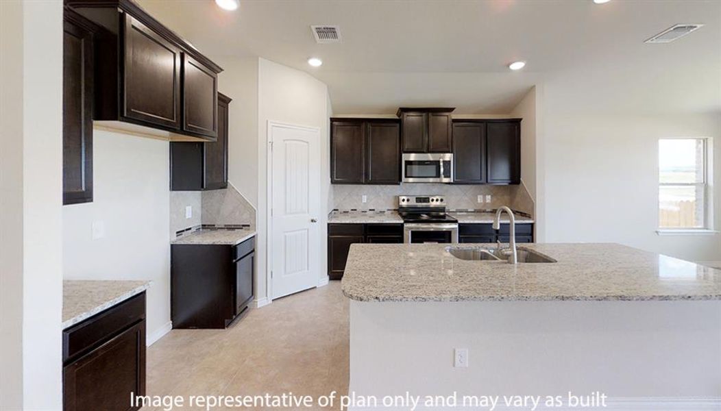 Kitchen with light stone counters, appliances with stainless steel finishes, dark brown cabinets, tasteful backsplash, and recessed lighting Kitchen with light stone counters, appliances with stainless steel finishes, dark brown cabinets, tasteful backsplash, and recessed lighting