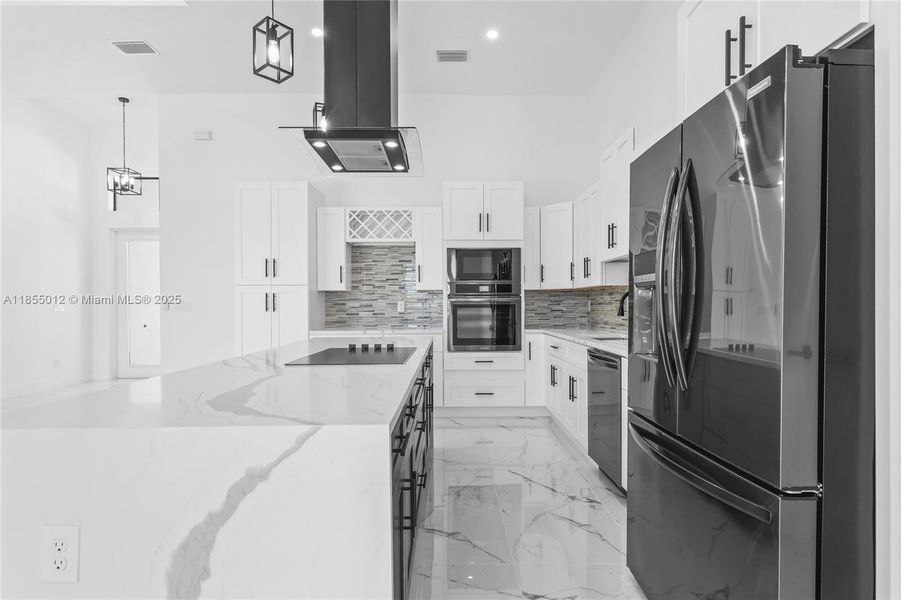 Cooktop on the Island, allows you to still entertain while cooking. Note- stunning Quartz Counters!
