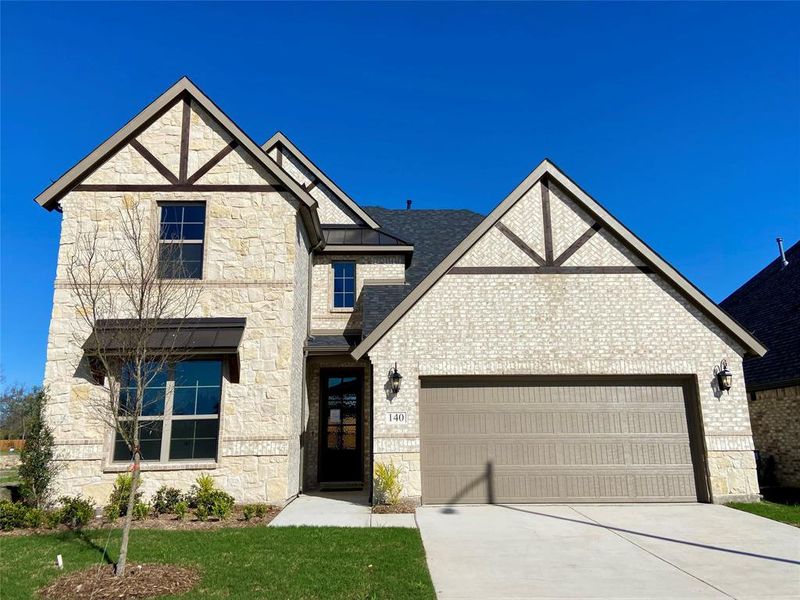 Elegant home with brick, stone, meatal roof accents, and inlaid cedar accents. Elegant home with brick, stone, meatal roof accents, and inlaid cedar accents.