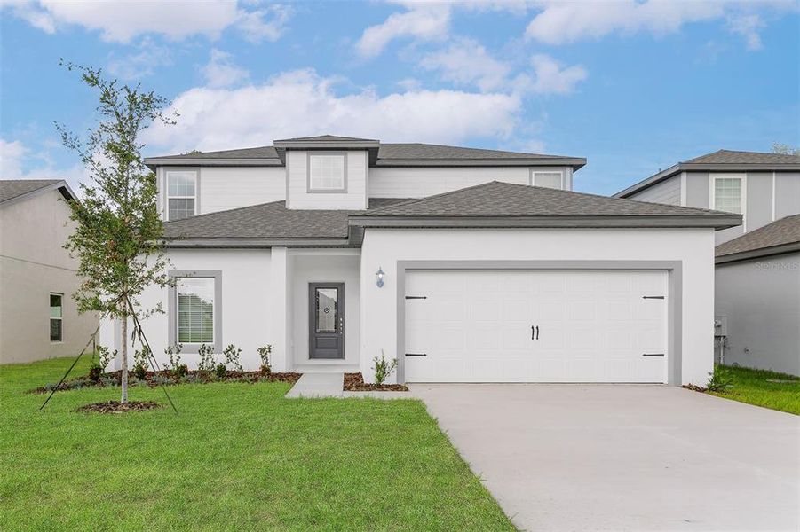 Front exterior of a new home in Tula Parc, Astatula, FL, highlighting curb appeal (Image 26).