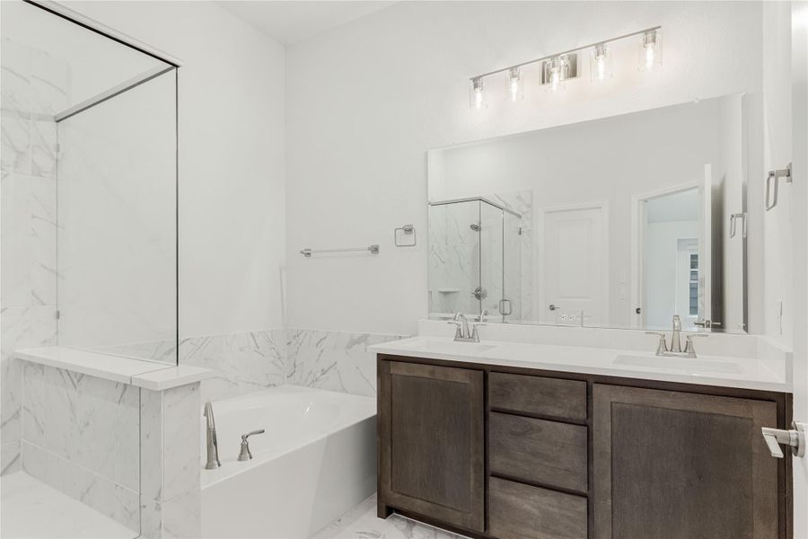 Master bathroom with double vanity, marble soaking tub, and glass shower enclosure Master bathroom with double vanity, marble soaking tub, and glass shower enclosure