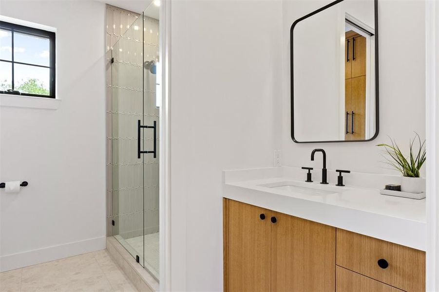 Full bath with vanity, a shower stall, and tile patterned floors