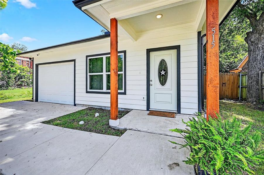 Property entrance with an attached garage and driveway Property entrance with an attached garage and driveway