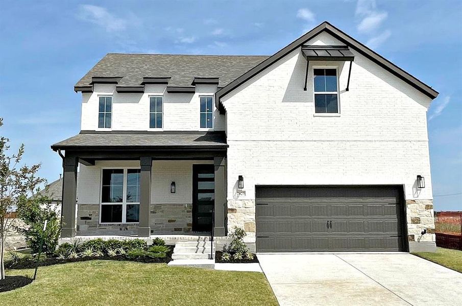 View of front of house featuring covered porch, painted brick with stone accents and concrete driveway View of front of house featuring covered porch, painted brick with stone accents and concrete driveway