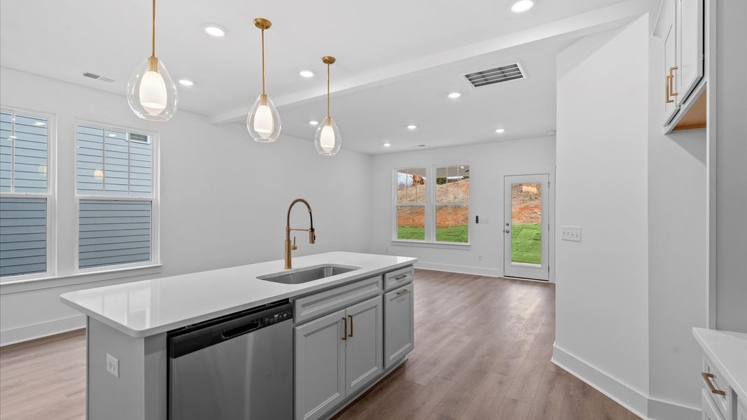 Accomplished design in a kitchen that blends function and form with a right-sized island at Pleasant Falls