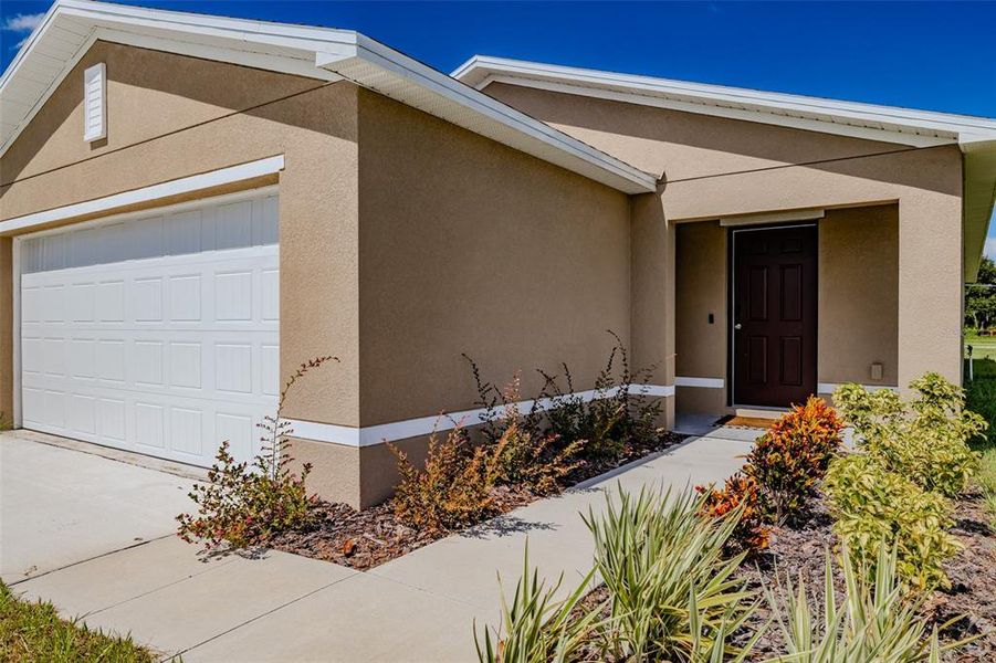 Front exterior of a new home in , Eagle Lake, FL, highlighting curb appeal (Image 1).