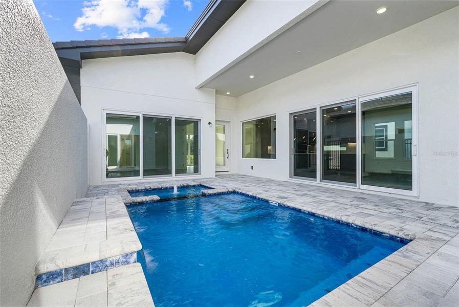 Exterior details and patio area of a home in Hampton Green at Providence, Davenport (Image 28).
