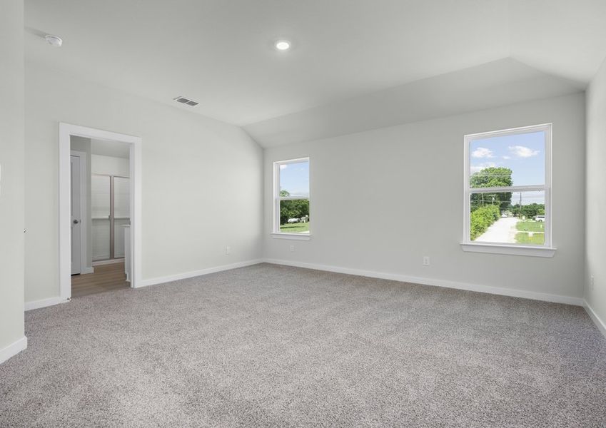 Incredible master suite with two windows for natural light, a high vaulted ceiling and private bath.