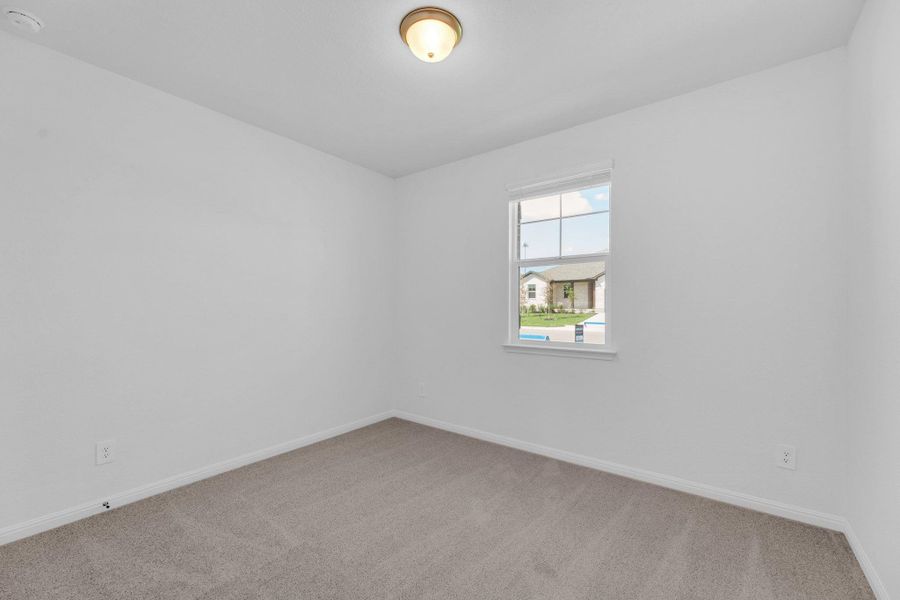 Empty room featuring light carpet and baseboards Empty room featuring light carpet and baseboards