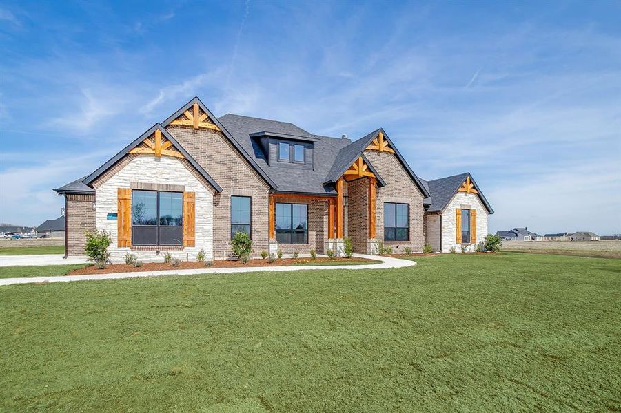 Front exterior of a new home in Waterfall Ranch Estates, Waxahachie, TX, highlighting curb appeal (Image 27).