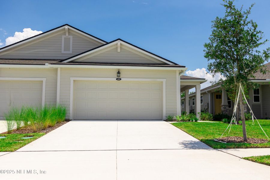 Front exterior of a new home in RiverTown - WaterSong, St. Johns, FL, highlighting curb appeal (Image 2). Front exterior of a new home in RiverTown - WaterSong, St. Johns, FL, highlighting curb appeal (Image 2).