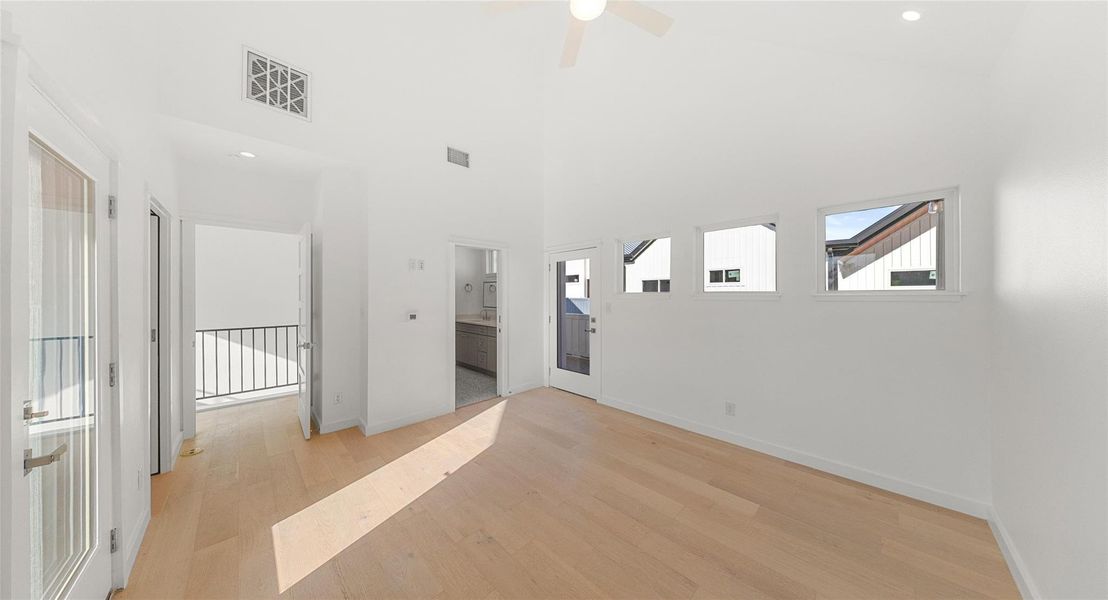 Warm wood flooring and abundant light create a space that feels like home the moment you walk in. Model No. 104 Shown.