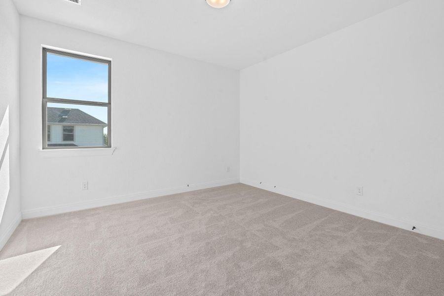 Unfurnished room with light carpet and baseboards Unfurnished room with light carpet and baseboards