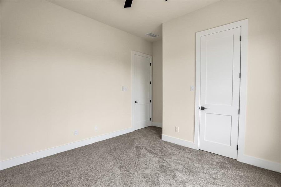 Unfurnished bedroom with carpet flooring and ceiling fan Unfurnished bedroom with carpet flooring and ceiling fan