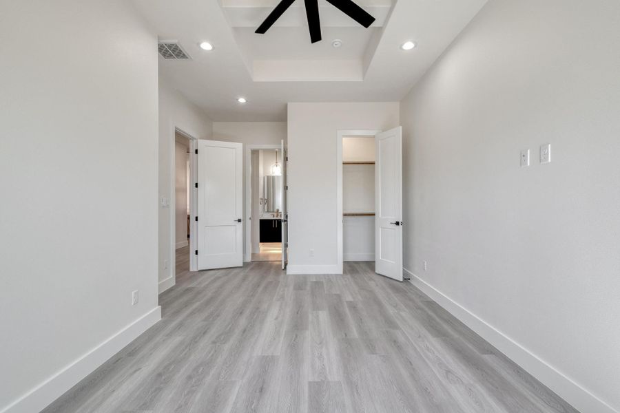 Unfurnished bedroom with light wood-style flooring, recessed lighting, baseboards, and visible vents