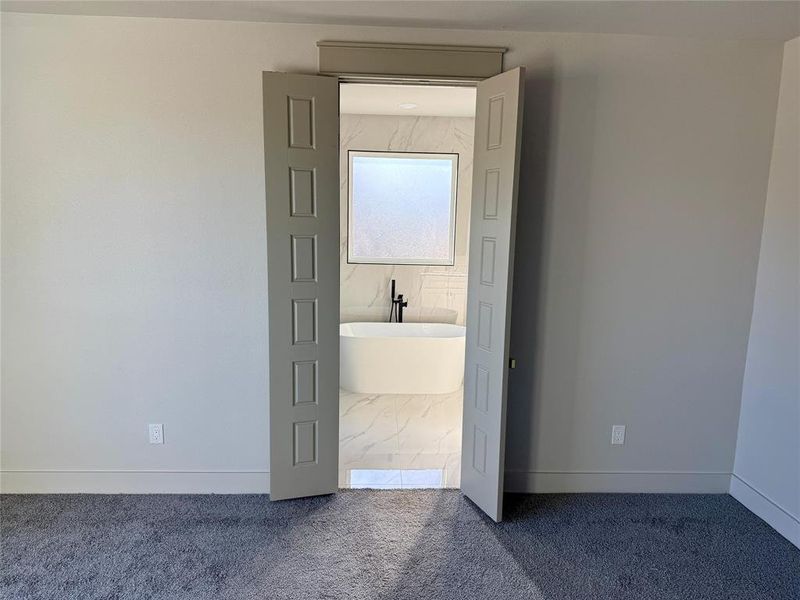 Unfurnished bedroom featuring carpet flooring and baseboards