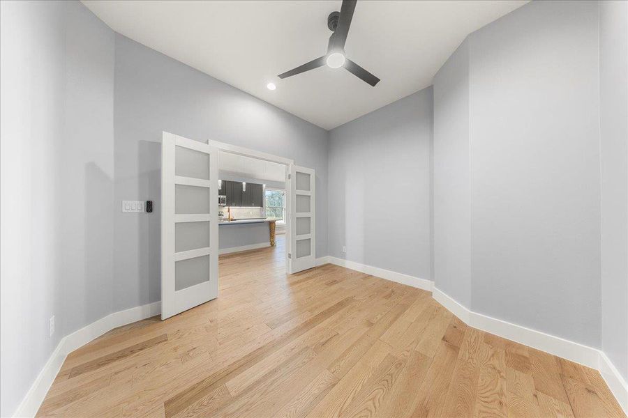 Spare room with light wood-style floors, recessed lighting, ceiling fan, and built in features Spare room with light wood-style floors, recessed lighting, ceiling fan, and built in features