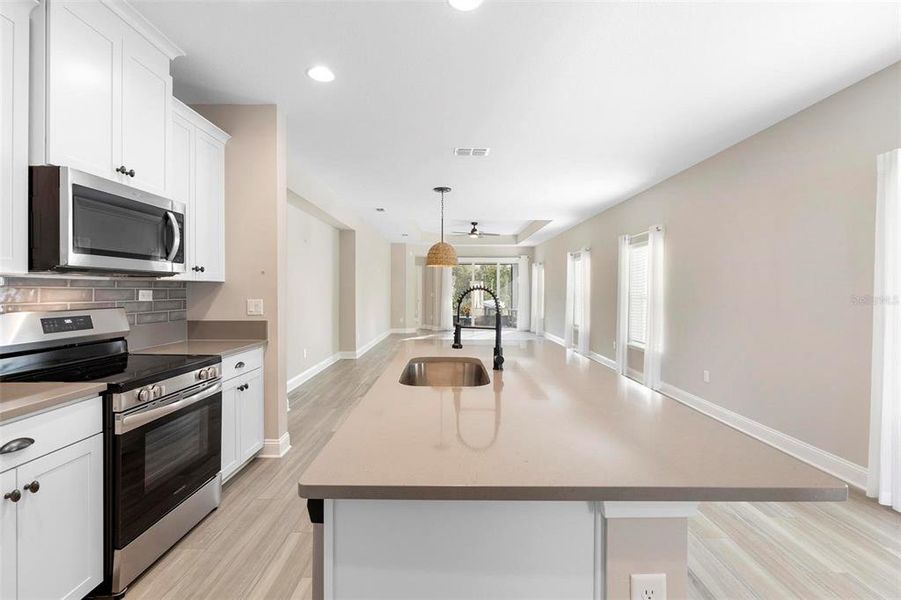 The gorgeous kitchen features a large island, providing both style and functionality, perfect for cooking, entertaining, or simply enjoying a meal in a beautiful space.