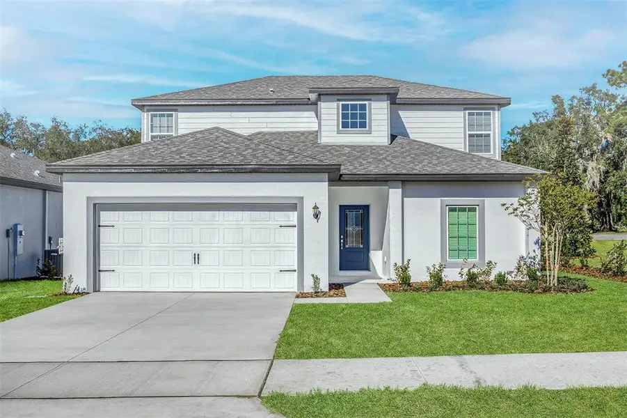 Front exterior of a new home in Tula Parc, Astatula, FL, highlighting curb appeal (Image 2). Front exterior of a new home in Tula Parc, Astatula, FL, highlighting curb appeal (Image 2).