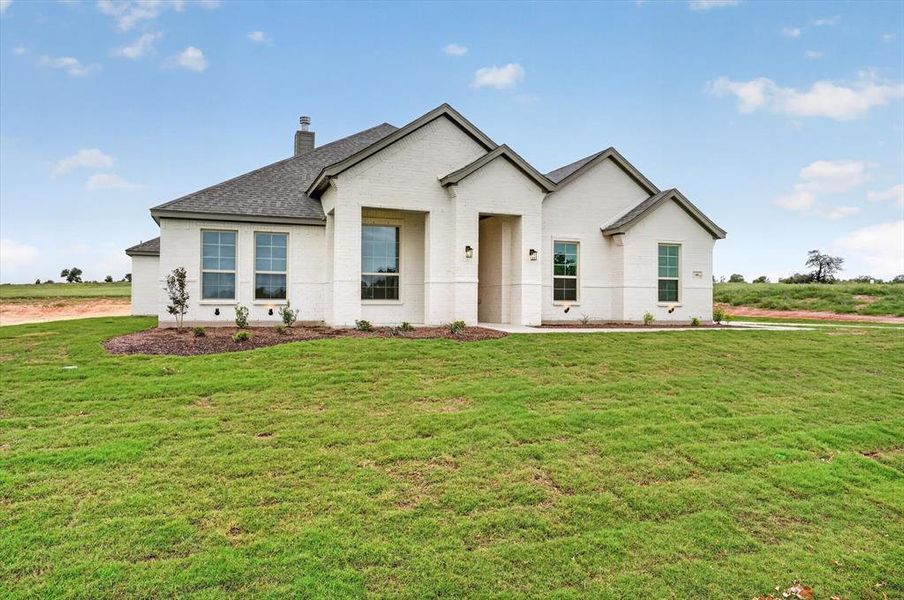 Contemporary single-story residence featuring a light-colored brick exterior Contemporary single-story residence featuring a light-colored brick exterior