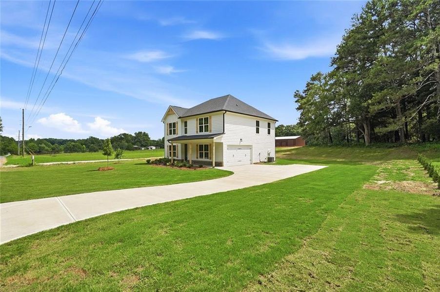 Front exterior of a new home in , Mansfield, GA, highlighting curb appeal (Image 31). Front exterior of a new home in , Mansfield, GA, highlighting curb appeal (Image 31).