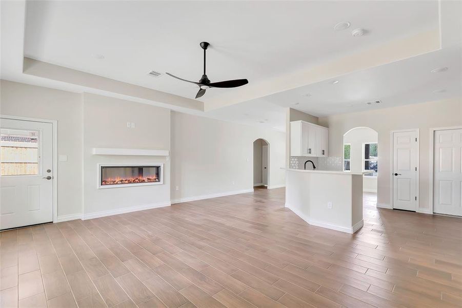 Large family room open to the kitchen. Beautiful high-end fireplace