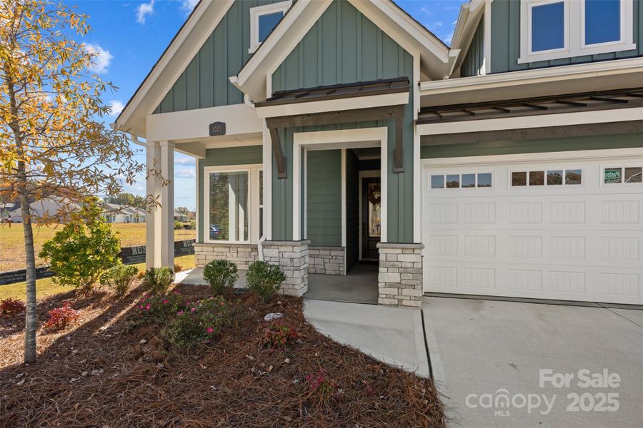 nOTE THE TRANSOM WINDOWS WHICH GIVE THE GARAGE NATURAL LIGHT AND THE CUTE ENTRANCE WAY