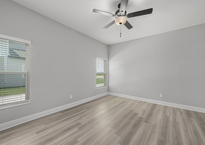 Windows let in plenty of natural light to this master bedroom.
