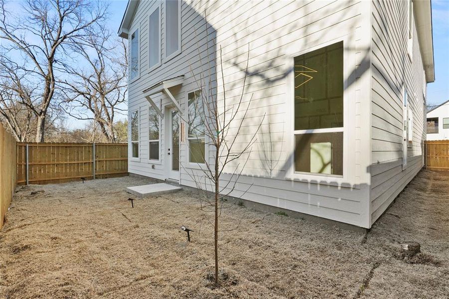 View of property exterior featuring a fenced backyard