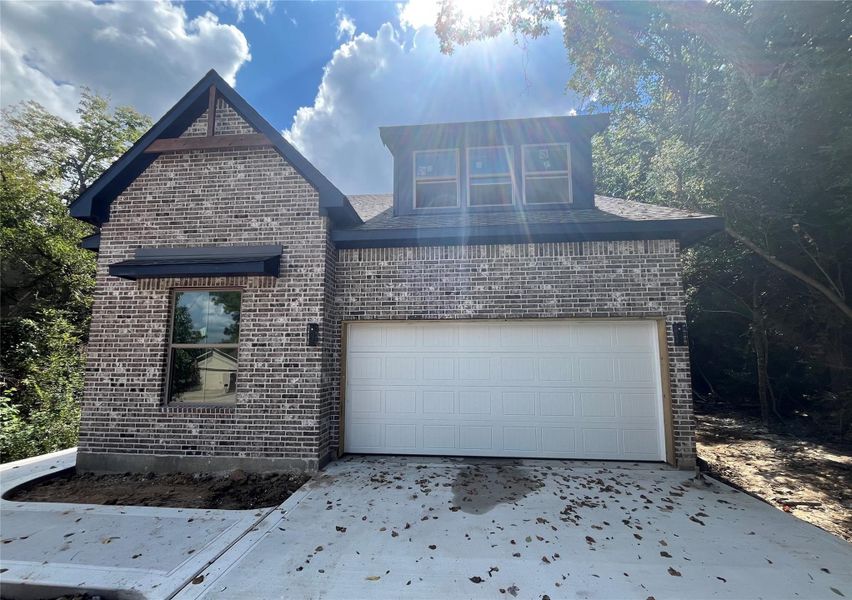 Front exterior of a new home in , Conroe, TX, highlighting curb appeal (Image 1).