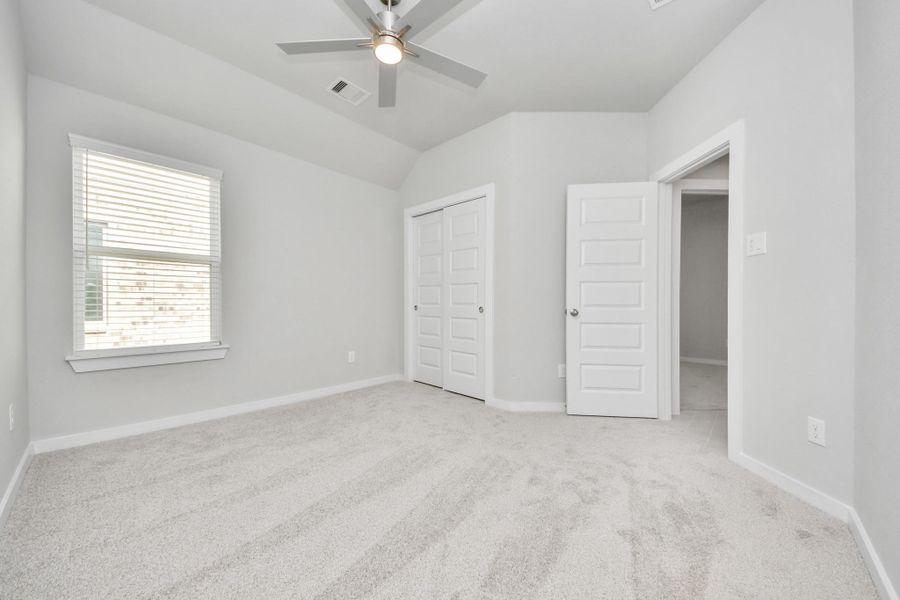 Generously sized secondary bedrooms featuring spacious closets, soft and inviting carpeting underfoot, large windows allowing plenty of natural light, and the added touch of privacy blinds for your personal retreat. Sample photo of completed home with similar floor plan. Actual colors and selections may vary.