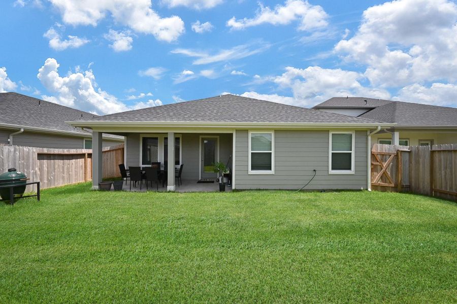 Cozy backyard with a covered patio, perfect for outdoor dining and relaxation. The yard is fenced, providing privacy which adds to the inviting atmosphere. Cozy backyard with a covered patio, perfect for outdoor dining and relaxation. The yard is fenced, providing privacy which adds to the inviting atmosphere.