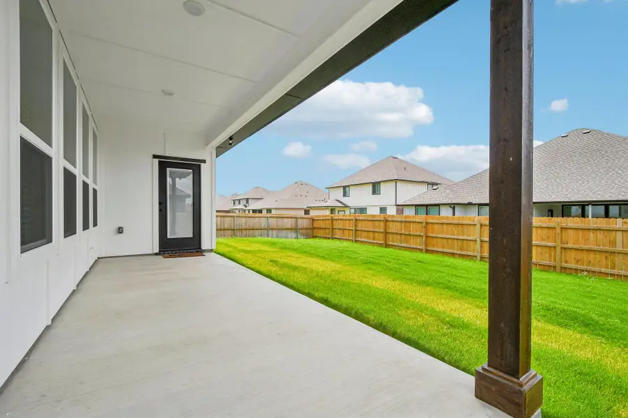 A spacious covered patio provides a delightful outdoor living space overlooking a lush, green yard. A spacious covered patio provides a delightful outdoor living space overlooking a lush, green yard.