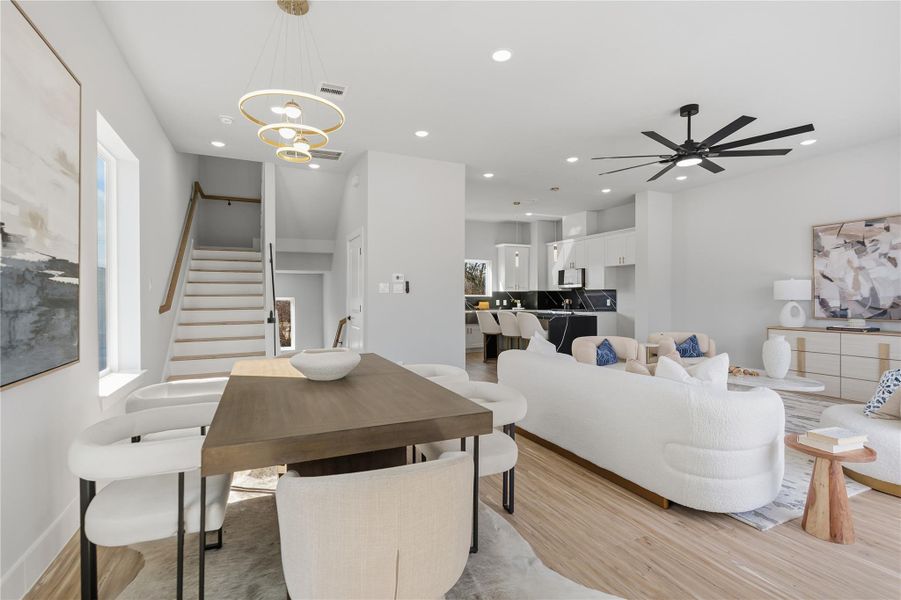 Open-concept living, dining, and kitchen with designer lighting, high ceilings, and abundant natural light.Perfectly designed for entertaining with seamless flow and modern finishes throughout.