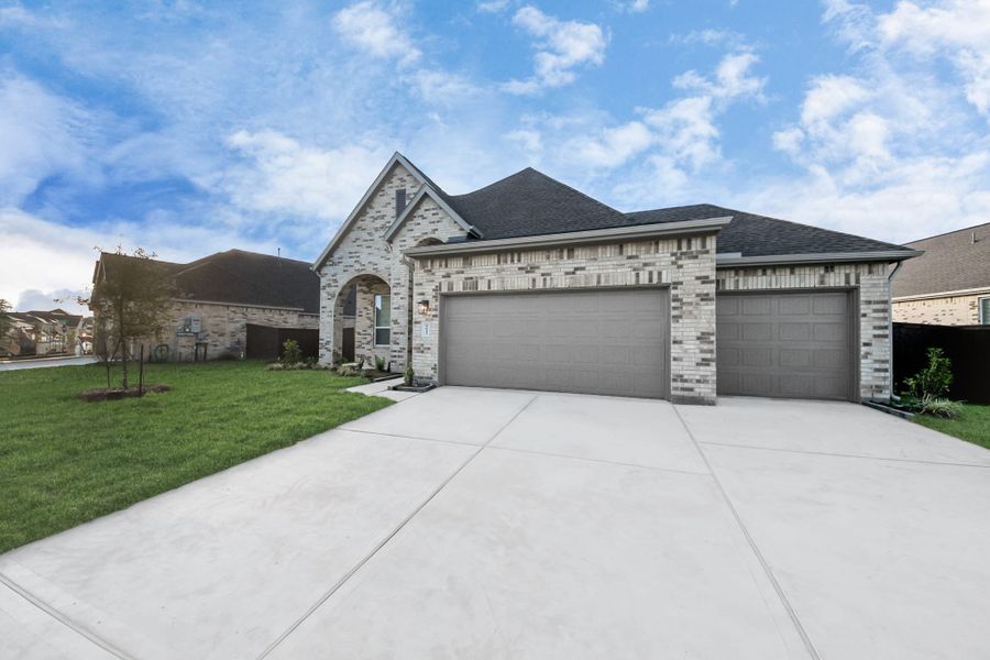 Front exterior of a new home in Meridiana, Manvel, TX, highlighting curb appeal (Image 27).
